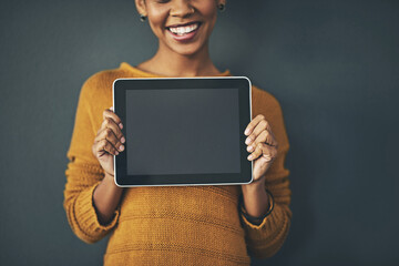 Woman holding digital tablet with a blank screen, copy space or chromakey for online advertising....