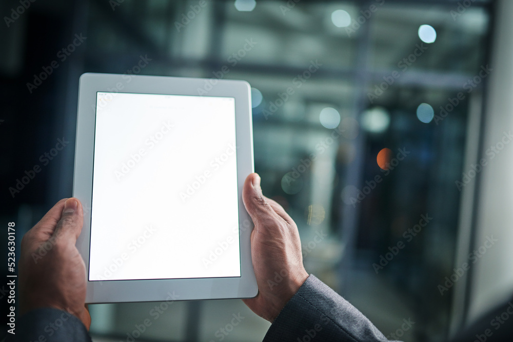 Poster Man holding tablet in hand with blank screen over a isolated copy space background. Closeup of businessman hands on a digital tablet in a modern office working late at night.