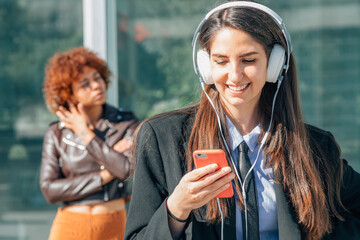 business woman with mobile phone and headset in the city