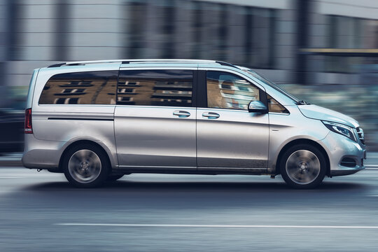 Silver passenger van Mercedes-Benz W447 Viano in the city street in motion. Luxury fast Mercedes Vito van