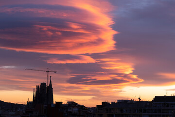 Silhouette of the Sagrada Familia in Barcelona at sunset with curious cloud formation.