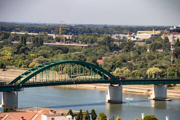 Old metallic green bridge over River Sava, made in 1884, destroyed during 1st world war, renovated in 1921 year, in Belgrade, capitol of Serbia - obrazy, fototapety, plakaty