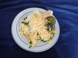 scrabbled eggs with vegetales served on a plate