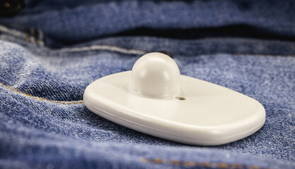 anti-theft tag or tag, security tag with sensor and electronic warning, electronic security equipment, on denim clothing