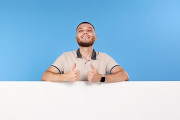 cheerful man holding board with empty copy space