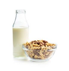 Breakfast cereal flakes in bowl and milk isolated on white background.