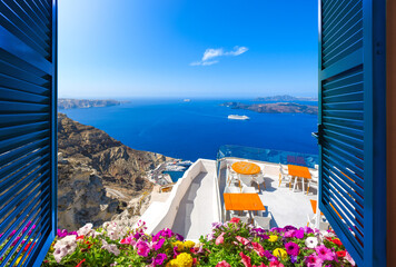 Open window with shutters overlooking a whitewashed tourist resort area, blue sea and the cruise port at Thera, Greece, on the island of Santorini. - obrazy, fototapety, plakaty