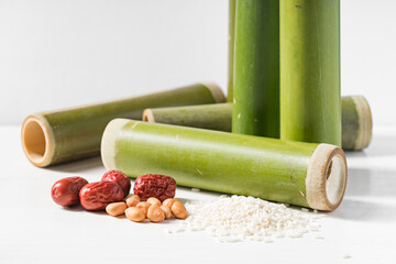 Bamboo tube and sticky rice on white background