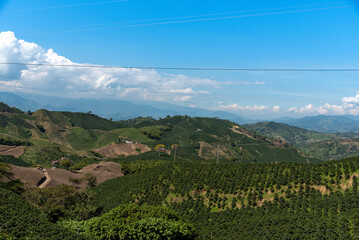 Fototapeta na wymiar Crop fields between hills in a Colombian country landscape.