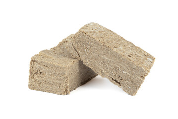 Pieces of sunflower halva on a white background.