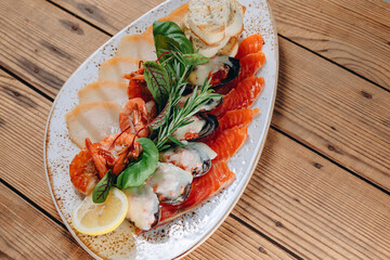 There is a decorative plate with new seafood dish in the restaurant.