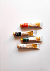 Composition with a oil paint on white background. Flat lay, top view, copy space.