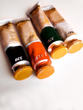 Composition with a oil paint on white background. Flat lay, top view, copy space.