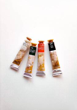 Composition with a oil paint on white background. Flat lay, top view, copy space.