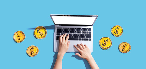 Person using a laptop computer with coins - earn online - work from home themes