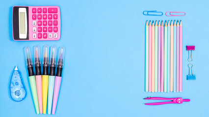 Creative Back to school copy space background with school supplies on blue theme. Flat lay