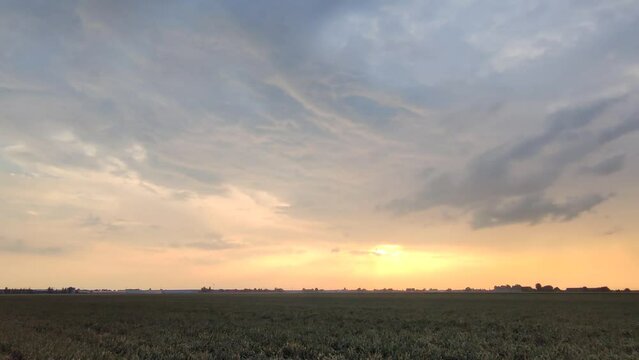 Panoramic footage of dramatic looking storm clouds over agricultural Dutch landscape on a summer evening.