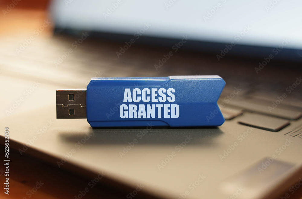 Aufkleber on the laptop keyboard is a flash drive with the inscription - access granted