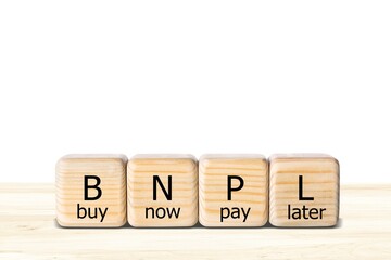 BNPL text in wooden blocks. Buy now pay later concept on the background