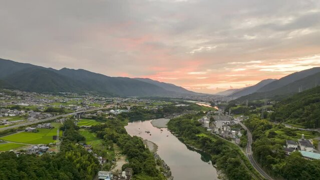 Hyperlapse: Sunrise over river through valley and rural towns in mountain landscape
