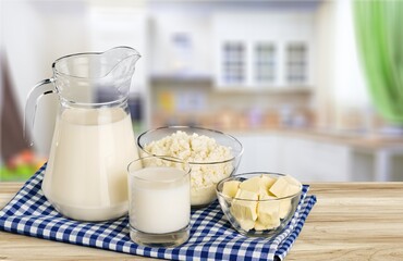 Milk, yogurt, cheese, butter on light table, variety of dairy products
