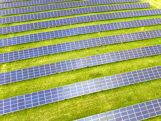 Solar panels  farm on a field. Green energy renewable resources and clean environment background.