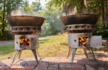 Hiking pot, Bowler in the bonfire. in cauldron at the stake. Traveling, tourism, picnic cooking,...