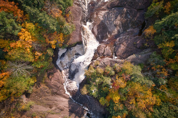 Overhead shot of a waterfall and rocky terrain during the fall or autumn season.