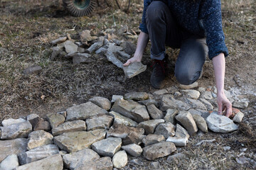 Stone Work on a Country Road by Female Expertise hands