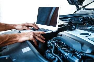 car service concept photo. car electrician doing car diagnostics. computer diagnostics of the vehicle engine concept. car engine chip tuning