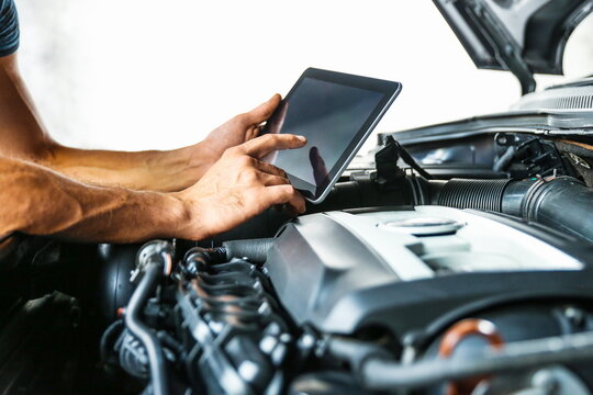 car service concept photo. car electrician doing car diagnostics. computer diagnostics of the vehicle engine concept. car engine chip tuning