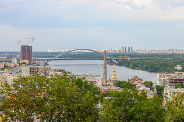 Fototapeta na wymiar beautiful view of summer Kiev. Roofs of Podol and a view of the left bank