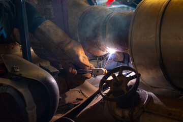 The welder is assembling valve to the pipe line with Shielded Metal Arc Welding process. The welder...