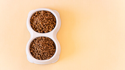 Meal for dog or cat. Canned meat with sauce and dry kibble food isolated on white background.