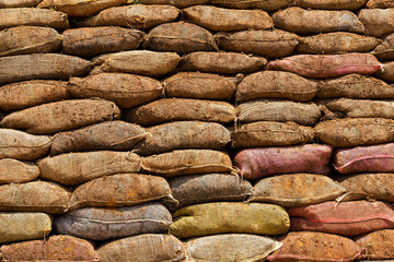 Retaining wall with sacks filled with earth to prevent landslides