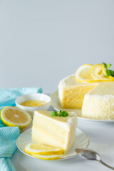 Lemon cake with coconut flakes. Piece of delicate vanilla dessert with cream.