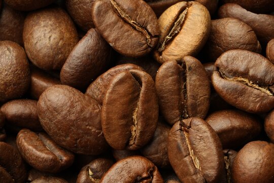 Pile of roasted coffee beans as background, closeup