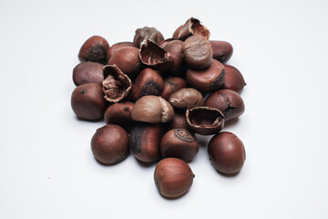 Chestnuts on white background. Pile of fresh chestnuts ready to roast. Top view, copy space. Flat lay. Space for text