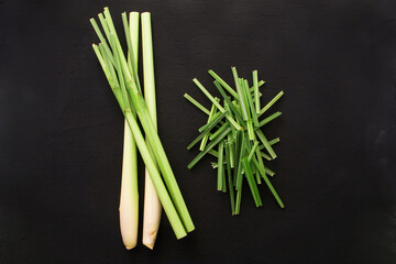 Fresh lemongrass with slice leaf on black background , top view , flat lay.