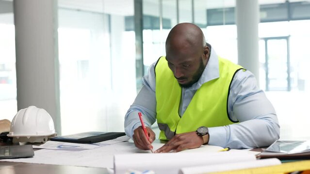 Architect, building planner or construction worker writing and drawing on plans or blueprints. Architecture and planning with a design professional at work on schematics for remodelling or renovation