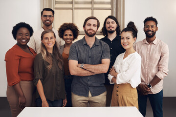 Group portrait of confident, diverse and proud businesspeople standing together showing teamwork...