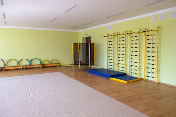 Lardge empty elementary school or kindergarten modern gym room with sport and recreational equipment - obrazy, fototapety, plakaty