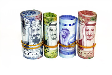 Money banknotes rolls of 50 SAR fifty Saudi Arabia riyals, 50 fifty United Emirates Dirhams...