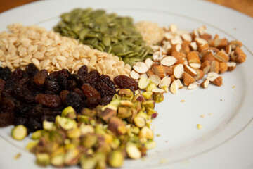 Close up shot a dish full of different seeds and nuts, chestnut,almond, raisin, pumpkins, seasame. Healthy eating concept 