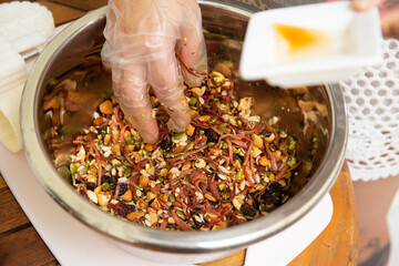 Female hands making dough for mooncake, homemade cantonese moon cake pastry on baking tray before baking for traditional festival. Travel, holiday, food concept