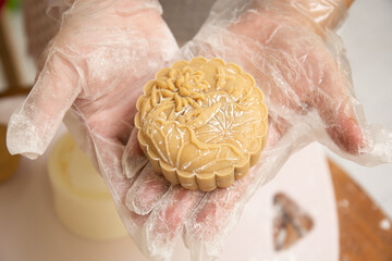 Raw mooncake placed in a baking tray by a window in a lifestyle setting
