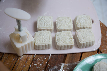 Retro vintage style Chinese mid autumn festival foods. Traditional mooncakes on table setting
