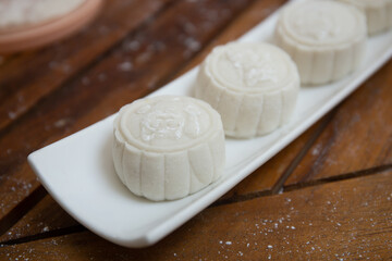 Retro vintage style Chinese mid autumn festival foods. Traditional mooncakes on table setting
