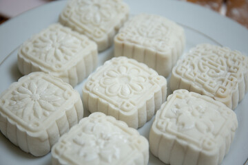 Retro vintage style Chinese mid autumn festival foods. Traditional mooncakes on table setting
