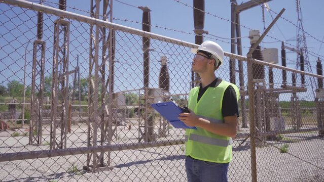Coal power plant switchyard.
The engineer works in the switchyard of the power plant.
